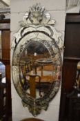 A Venetian style oval wall mirror.