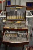 A mahogany canteen of cutlery on stand.