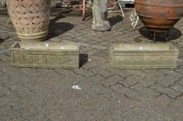 A pair of composite rectangular garden planters.