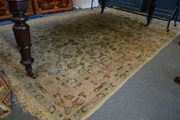A Kirman carpet, cream ground with floral decoration (some fading and wear) 330cm x 220cm.