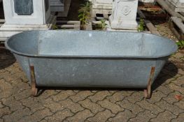 A large galvanised bath/planter.