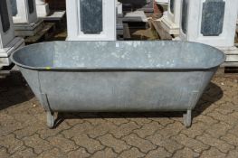 A large galvanised bath/planter.
