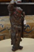 A Chinese carved wood figure.