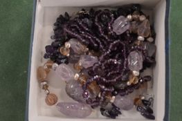 A box of amethyst necklaces etc.