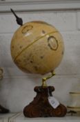 A table globe on decorative stand.