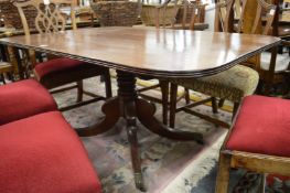 A 19th century mahogany rounded rectangular tilt top breakfast table on turned column support.