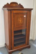 An Edwardian inlaid mahogany music cabinet.