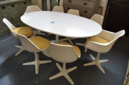 A 1960's large oval Arkana Tulip table with eight chairs to include two swivel armchairs and a spare