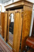 A Victorian satinwood wardrobe.