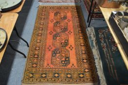 A gold ground Afghan rug 200cm x 110cm.
