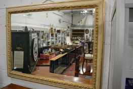 A large decorative gilt framed mirror.
