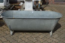 A large galvanised bath/planter.