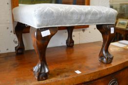 An upholstered stool.