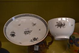 A porcelain tea bowl and saucer painted on en grisaille.