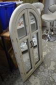 A decorative window style mirror.