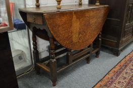 An oak oval dropleaf gateleg dining table.
