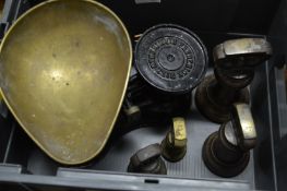 Kitchen scales and a set of bell-shaped weights.