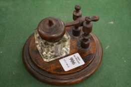 An unusual wooden and glass inkwell.
