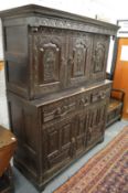 An Elizabethan revival carved oak court cupboard.