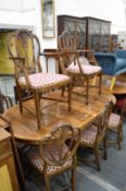 A set of eight Sheraton style mahogany dining chairs, two with arms, all with Prince of Wales carved