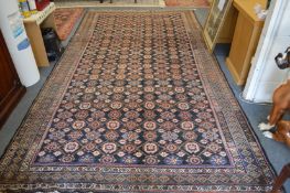 A Melahir long carpet, dark blue ground with decoration of numerous floral palmettes 400cm x 220cm.