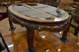 A Chinese hardwood coffee table with inset glass panels.