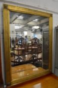 A large decorative gilt framed mirror.