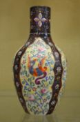 An enamel decorated opaque glass vase.