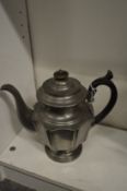 A pewter tea pot.