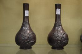 A pair of Japanese bronzed spelter bottle vases.