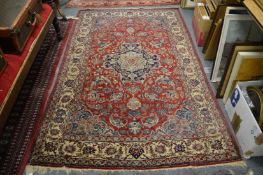 A good Persian rug, possibly Isfahan, red ground with floral decoration 230cm x 155cm.