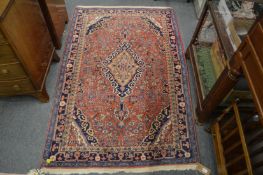 A Persian rug, pink ground with stylised floral decoration 160cm x 105cm.