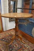 A 19th century oak tripod table.