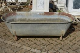 A large galvanised bath/planter.