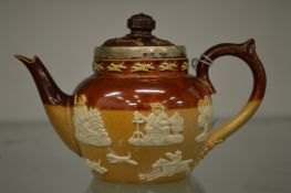 A miniature Doulton salt glazed teapot with silver rim.