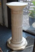 An alabaster pedestal stand.