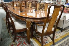 A Chinese extending dining table with two leaves together with a set of eight dining chairs to