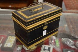 A black Jappaned cash box containing a small collection of coins.