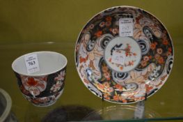An imari tea bowl and saucer.