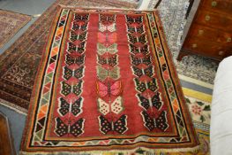 An unusual Persian design modern rug decorated with butterflies 190cm x 135cm.