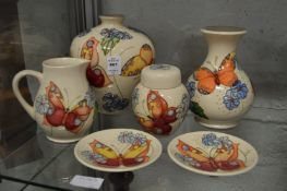A group of six items of modern Moorcroft, cream ground decorated with butterflies to include two