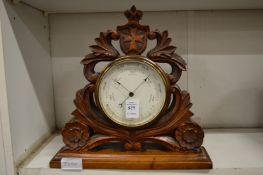 A Victorian carved walnut framed desk barometer.