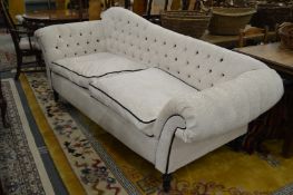 A good button upholstered shaped back large two seater settee.