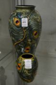 Two modern Moorcroft vases, moulded decoration depicting peacock feathers.