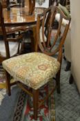 A pair of 19th century mahogany shield back dining chairs.