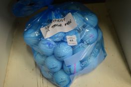 Twenty-five Titleist golf balls and twenty five Taylor Made golf balls.