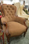 A Victorian mahogany framed button upholstered armchair.