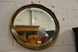 A brass framed oval mirror.