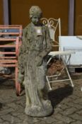 A large composite garden ornament of a classical female figure.
