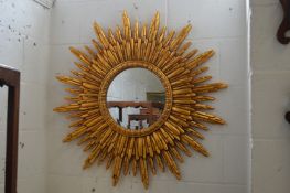 A sunburst wall mirror.